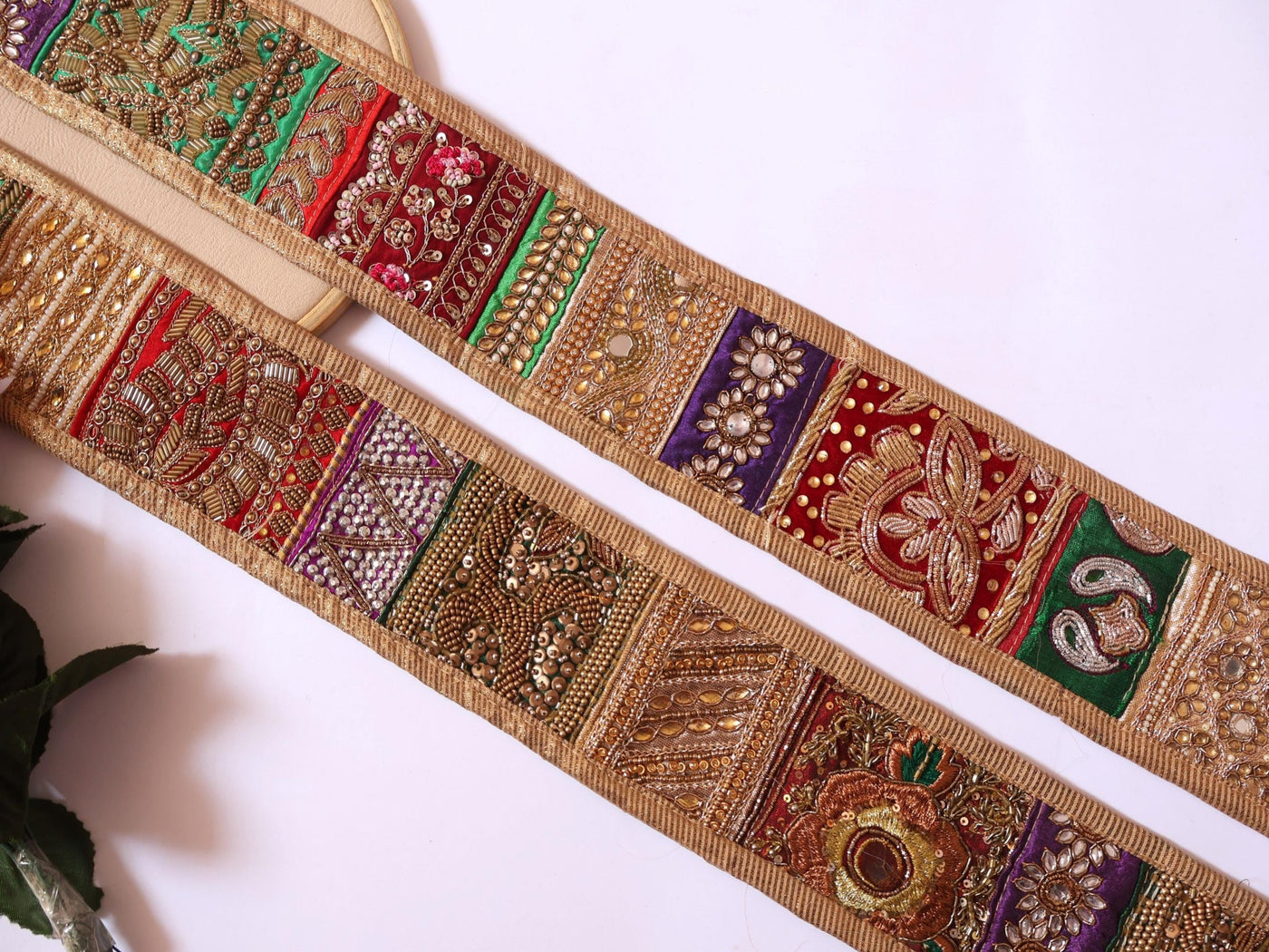 Decorative fabric strip with intricate patterns on a white background