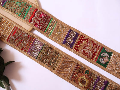 Decorative fabric strip with intricate patterns on a white background