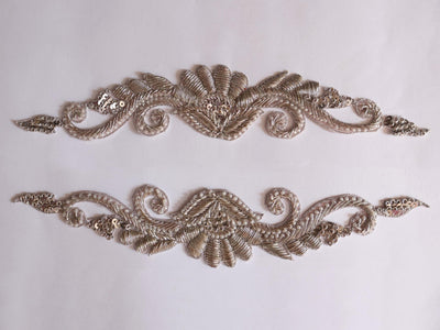A pair of silver embroidered applique patches with intricate handcrafted Indian brass artwork.